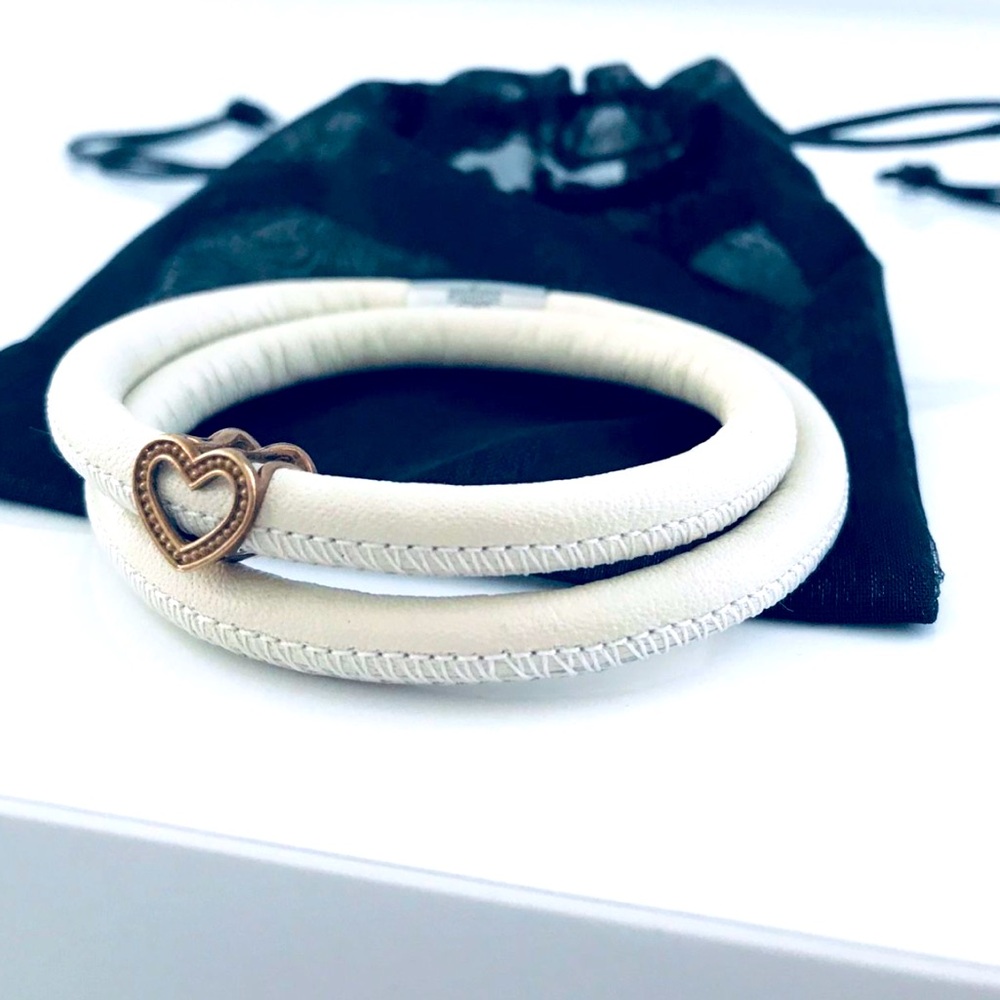 Leather beige bracelet with gold charm and jewelry pouch.